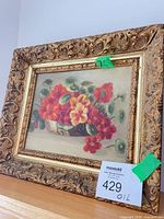 Full view of framed floral still life painting