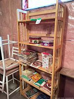 Full view of light wood bookcase with five shelves and slatted sides