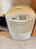 Front view of Kenmore dehumidifier showing control panel and grill