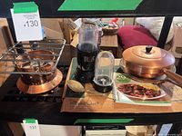 Full lot overview showing Magic Bullet set, copper skillet with lid, copper burner, stoneware pan box