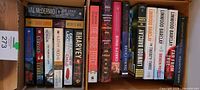Box with two rows of assorted paperback mystery and thriller books