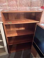 Front angled view of bookcase showing shelves and finish