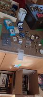 Overview of entire lot on countertop showing watches, stopwatch, jewelry pieces