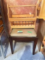 Front view of stool with attached rack showing overall design