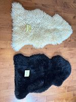 Cream and black sheepskin rugs side by side