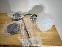 All components: two backplates, curved arm assemblies, single white opal glass shade, hardware