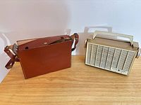 Radio and leather case side by side on table
