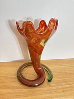 Front view of sculptural art glass vase showing colors and form