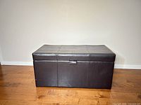 Front view of brown faux leather ottoman closed