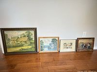 All four framed prints lined up on floor