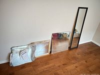 All mirrors leaning against wall showing full lot