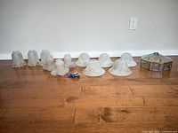 All lamp shades and fixture lined against wall