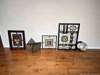 all wall décor pieces and clocks lined up on floor against wall