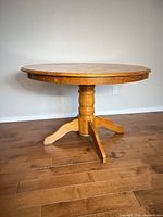 Full view of round honey oak pedestal dining table