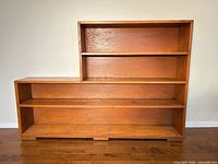 Front view showing entire asymmetric bookcase and shelf layout