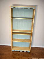 Front view showing entire bookcase, shelves, finish and color accents