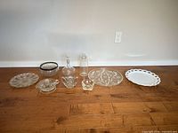 All nine glass serveware pieces lined up on floor