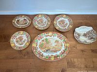 All six plates laid out to show sizes and designs