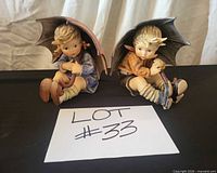 Pair of Goebel Hummel umbrella boy and girl figurines front view