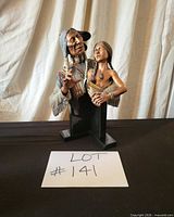 Busts of Indigenous man and girl on stone bases