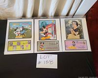 Overall view showing three matted Disney prints in sleeves