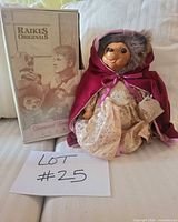 Bear doll posed beside original box with lot card visible
