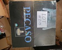 Box top showing Pecaso Swarovski branding