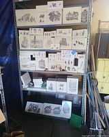 Shelf view showing multiple Department 56 grayscale boxes stacked in three rows