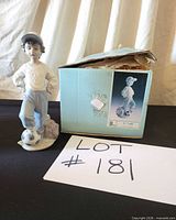 Figurine standing beside original box and lot card