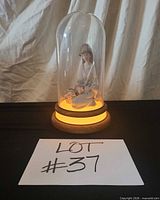 Entire lot with dome covering figurine on lit base