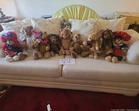 Group shot of all 10 teddy bears lined on sofa