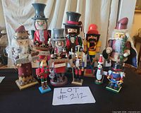 All ten nutcrackers grouped on table showing size range and accessories