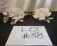 Both porcelain floral figurines side by side for scale and overview