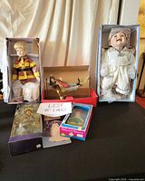 Group shot of all five boxed dolls on table