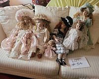 All six dolls seated on sofa for group view