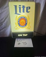 Front view of illuminated Miller Lite wall sign showing logo, medallion and ON TAP panel