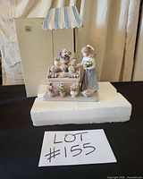 Full figurine with canopy on styrofoam base, box visible