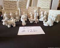 Group shot of 12 Precious Moments figurines with boxes