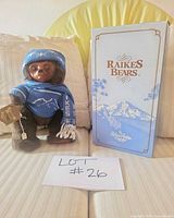 Bear wearing blue knit clothing with original box visible
