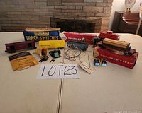 Entire lot layout showing rolling stock, wiring, controller, boxes, paperwork and track switch box