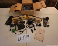 Overview of lot: box of track, transformers, controllers, accessories, paperwork