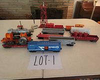 Overall group showing locomotive, six rolling stock cars, signal tower, signal post, and assorted loads