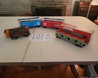 All four Lionel O gauge cars with some original boxes