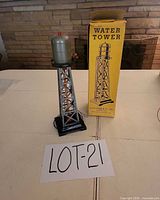 Full view of water tower beside box on table