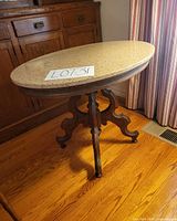 Full view of table showing marble top and pedestal base