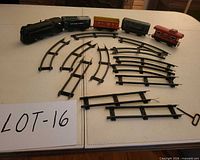 Overview of locomotive, tender, three cars, track pieces, key