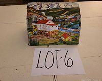 Front perspective of tin litho tunnel showing mountain mill scene