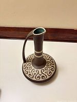 Oblique top view showing pitcher form, scroll pattern, turquoise interior