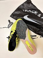 Pair of volt Nike track spikes with spike plate, spike wrench and drawstring bag