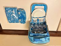 Backpack open with contents and separate packaged pouch visible